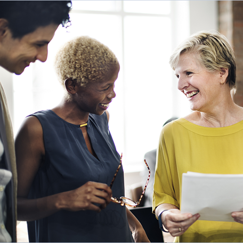 a diverse group of professionals engaged in a collaborative discussion around a table in a bright, modern workspace.